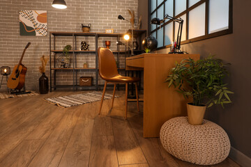 Poster - modern workplace with glowing lamp in interior of dark room