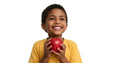 Young boy joyfully presenting a vibrant red apple against a black backdrop
