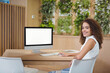 © WavebreakMediaMicro - African American woman sitting at desk in modern office using desktop computer keyboard, copy space