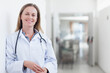 © WavebreakMediaMicro - Mid adult female doctor standing in hospital corridor with stethoscope and lab coat, copy space