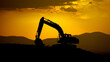 © 艺橙 张 - Excavator silhouette against vibrant sunset sky, construction site softly blurred in background.
