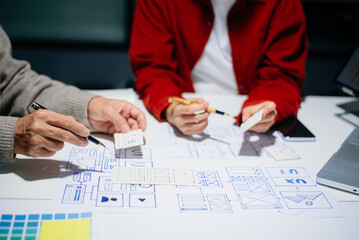 Wall Mural - UX graphic designer planning application process development prototype wireframe for web smart phone. Creative digital development agency.