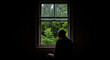 © sv_production - An elderly man sits near the window of an old house all alone.