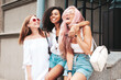 © halayalex - Three young beautiful smiling female in trendy summer clothes.Sexy carefree multiracial women posing on the street background.Positive models having fun in sunglasses. Cheerful and happy