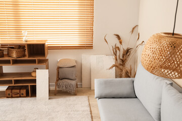Poster - cozy sofa and pictures on floor in living room