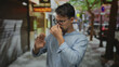 © Krakenimages.com - Young hispanic man in the city street outdoors reacting to a bad smell with a disgusted expression