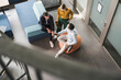 © Westend61 - Business colleagues planning strategy sitting on couch at office
