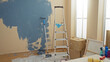 © Krakenimages.com - Room undergoing renovation shows paint supplies, ladder, and moving boxes scattered, suggesting a new apartment being prepared for home improvement indoors.