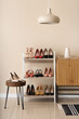 © Pixel-Shot - Interior of light room with female shoes, shelf unit and table