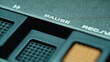 © stockbusters - Finger pressing pause button on retro tape player closeup. Thumb touching panel