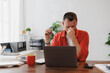 © Tj - Stressed mature entrepreneur taking off glasses and rubbing his eyes while working on laptop at home, suffering from dry eye syndrome or eye strain after long computer work