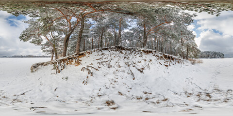 Wall Mural - winter full spherical 360 hdri panorama view on ice of frozen snow-covered lake in middle of forest in equirectangular projection. VR AR content