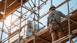 © tynza - A Latin American male builder working on scaffolding at a construction site, wearing a safety harness, urban development in progress.