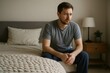 © Татьяна Евдокимова - Young man sitting on bed suffering from loneliness, depression and anxiety, mental health issues