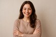 © Татьяна Евдокимова - Confident woman smiling warmly with arms crossed, exuding positivity and friendliness against a neutral background. Ideal for business or lifestyle themes