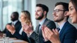© Matthew - Group of professionals applauding during a corporate presentation in a modern office setting