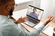 © Prostock-studio - Black Businessman Having Video Call Talking To Laptop With Empty Screen Sitting At Workplace In Modern Office. Modern Business Communication. Selective Focus, High-Angle Shot, Mockup