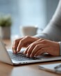 © aiLover - Close-up view showing person's hands typing keyboard. Laptop computer sits desk, coffee cup blurred background. Keyboard use, technology usage, work from home, remote work, typing, writing,
