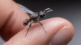 intricate robotic wasp on finger