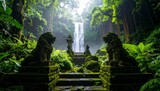 Serene waterfall view surrounded by lush green forest and ancient stone sculptures on a misty day.