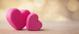 The charming pink hearts symbolizing love and togetherness on a wooden surface.