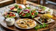 © lastfurianec - Traditional Greek dishes - salad, meze, pie, fish, tzatziki, dolma on the set table.