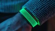 © Anousone - Fitness tracker sensor detail, green light on skin, pulse reading