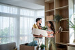 © Migma_Agency - Happy couple arranging belongings in new apartment after moving in