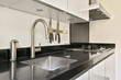 © ADDICTIVE STOCK - Modern kitchen design with sleek countertop and appliances