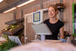 © ADDICTIVE STOCK - Woman working at organic farm stand with fresh produce