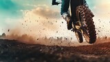 Motocross racer in mid-air, dirt flying