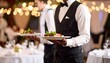 © Amenaa - Waitstaff carrying plates of food at a banquet