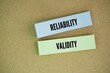 © Fauzi - Colored paper with the words reliability and validity. Reliability refers to the consistency of a measure, while validity refers to the accuracy of a measure.