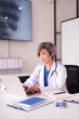 © Pichsakul - Asian adult female doctor busy working on laptop reviewing medical data in a modern professional healthcare clinic office using advanced technology
