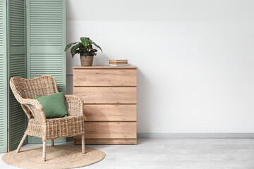 Poster - chest of drawers, armchair and folding screen in interior of living room