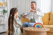 © Pixel-Shot - Male speech therapist working with little girl in office