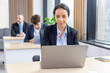 © unikyluckk - African american business woman working with laptop in modern meeting room. Multi-Ethnic Corporate Business Meeting. Female executive handling real estate project. Financial analysis.