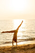 © BGStock72 - Handstand at sunset on the beach brings joy and tranquility to the moment