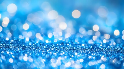 Sparkling bright blue glitter background texture with soft focus bokeh highlights creating a festive magical abstract backdrop perfect for celebrations holidays