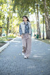 © Andrey_Arkusha - Full-length portrait of a young beautiful girl in a checkered shirt and beige pants