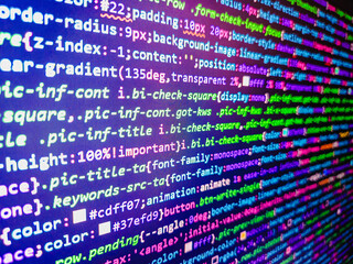 computer code background. colorful programming source typed on the screen of the monitor with shallo