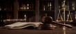 © Natallli - The gavel and scales of justice resting on a law book in a library setting.