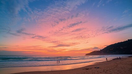 Wall Mural - Time lapse A stunning scene of a vivid sunset with pink and orange hues illuminating the sky over Karon beach Phuket. The serene water reflection create a peaceful and atmospheric view.