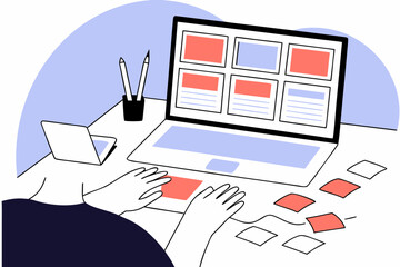 Person editing website content on a laptop with a clear wireframe layout on desk