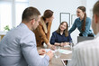 © New Africa - Business coach working with group of people in office