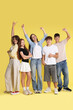 © New Africa - Full-length portrait of happy teenage friends on yellow background