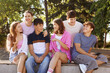 © New Africa - Group of happy teenage friends spending time together outdoors