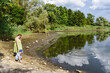 © Emanuele Capoferri - Mother and son enjoy nature by the water on a sunny day