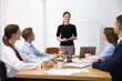 © New Africa - Business coach giving presentation to group of people in office