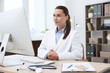 © New Africa - Doctor having online consultation via computer in clinic